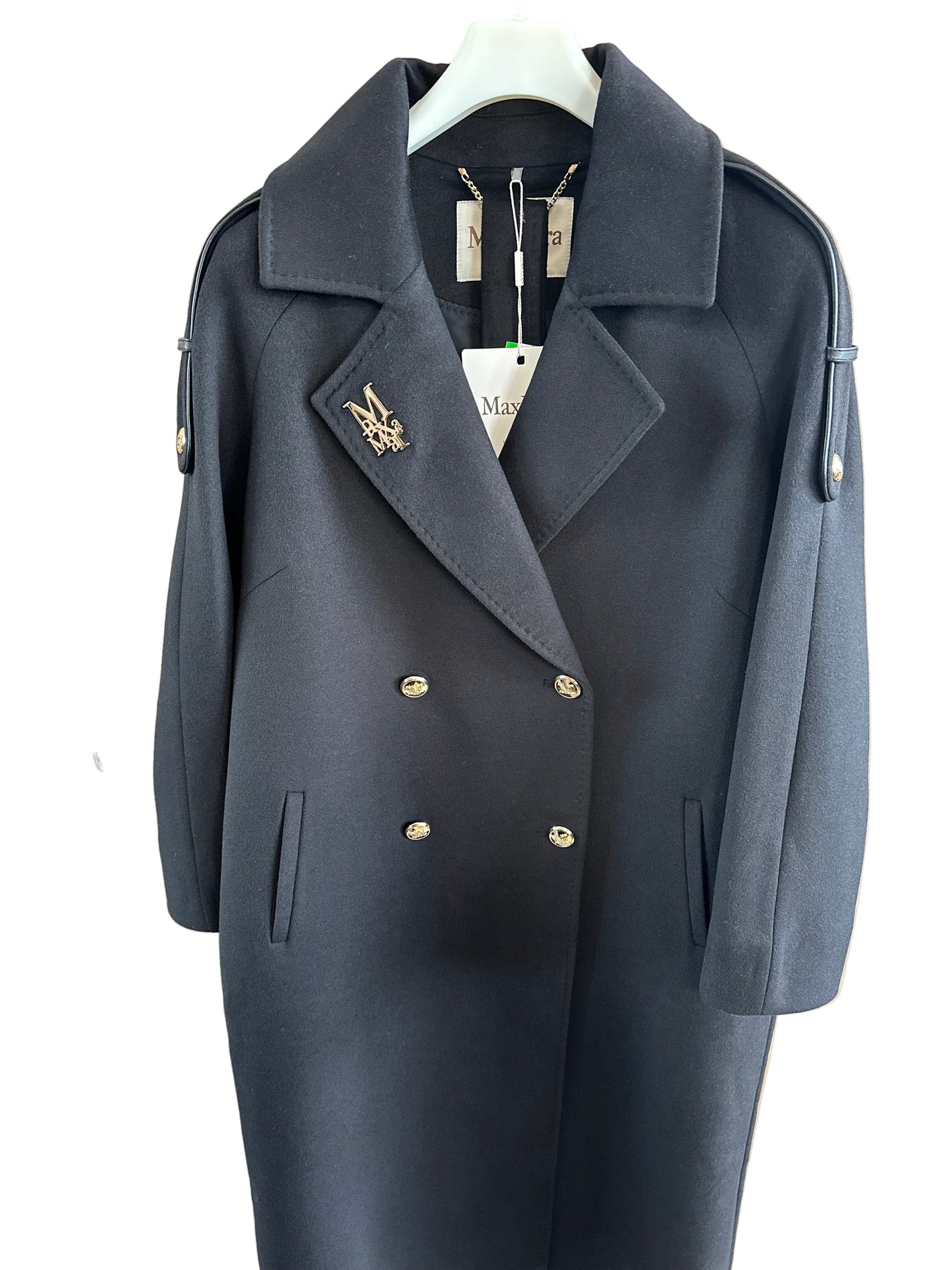 Dark gray suit jacket with gold buttons on a wooden surface