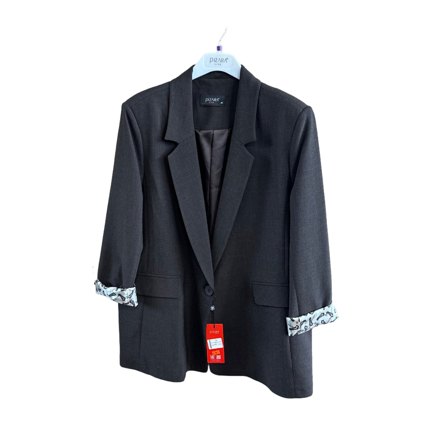 Black jacket on a wooden surface with tags attached