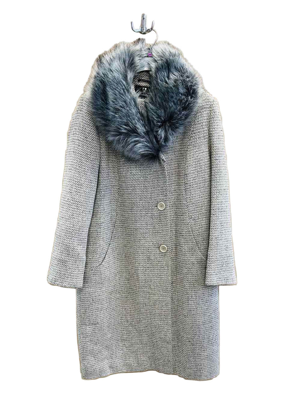 Gray coat with fur collar on a hanger against a wooden wall.