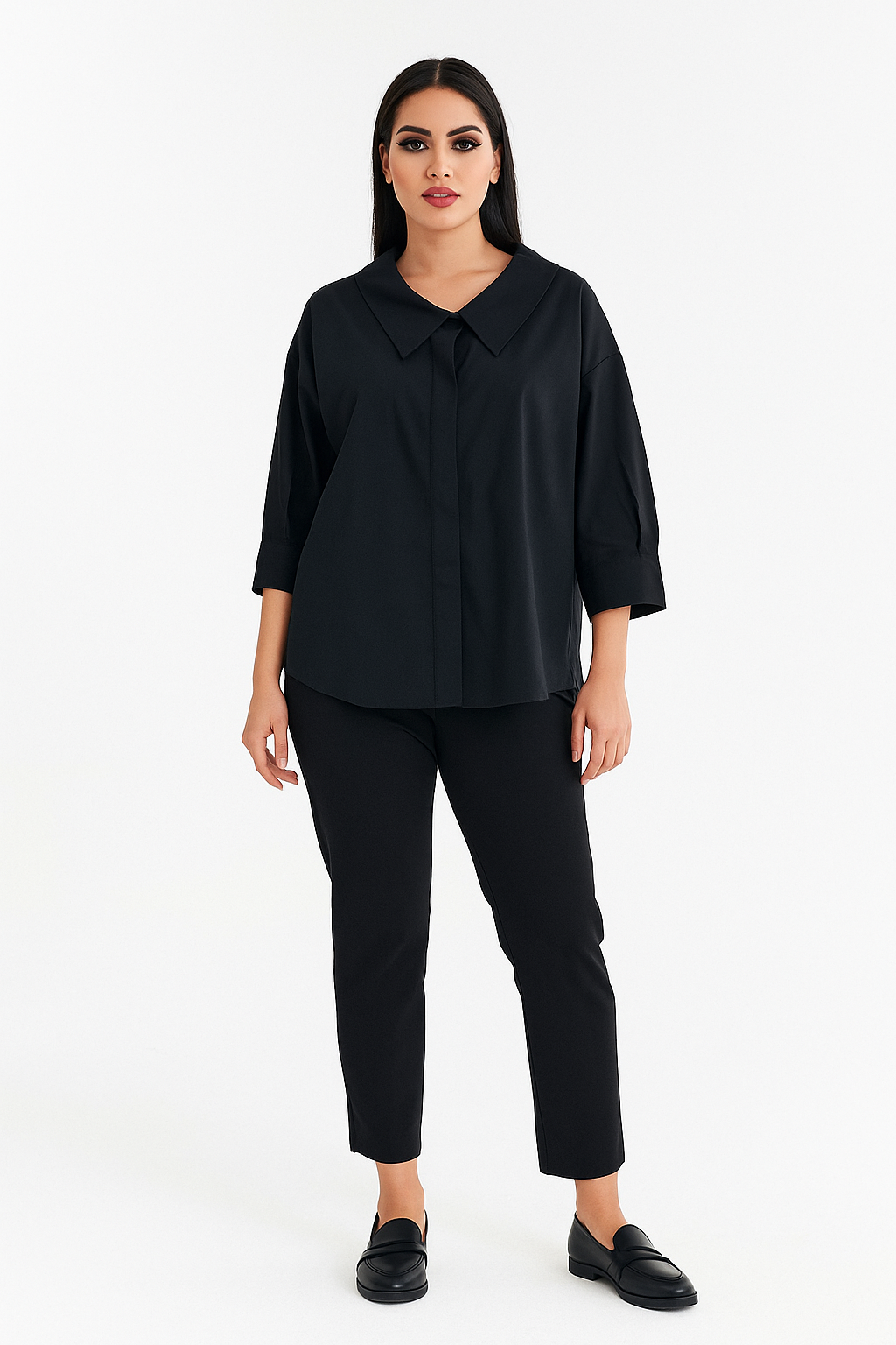 Woman wearing a black blouse and black pants on a white background