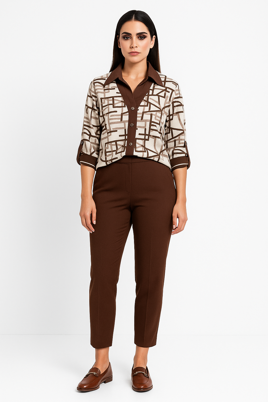 Woman wearing a patterned blouse and brown pants on a white background