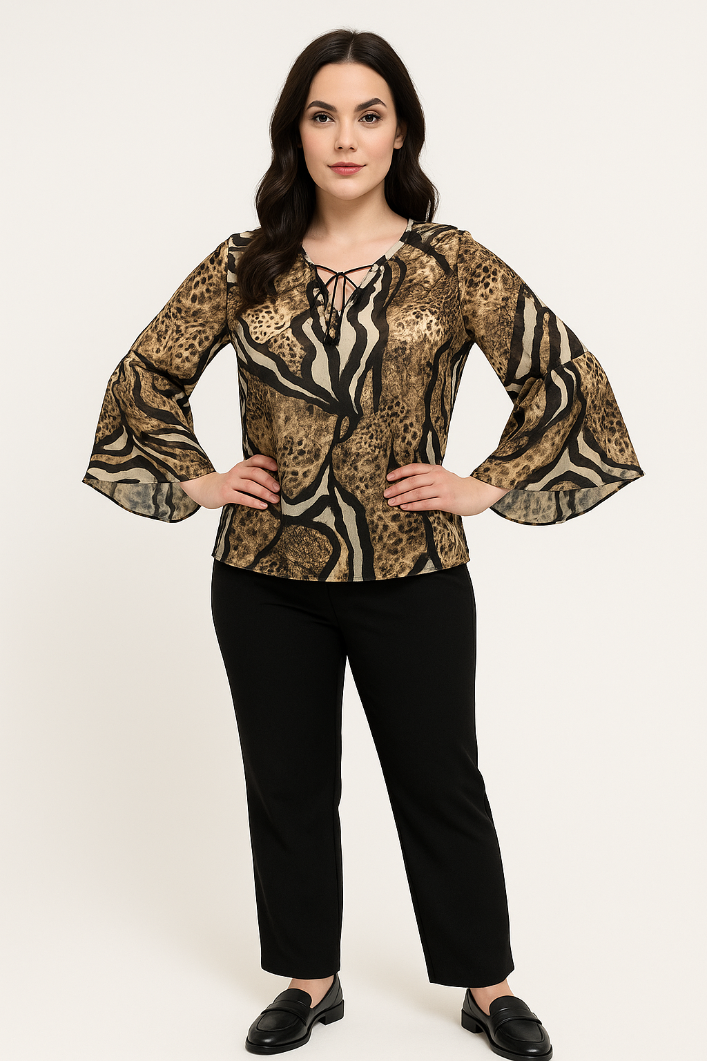 Woman wearing a leopard print blouse with bell sleeves on a white background