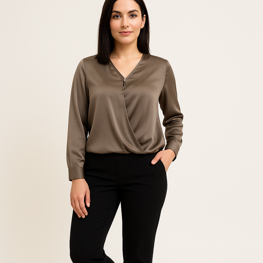 Woman wearing a brown long-sleeve top and black pants on a beige background