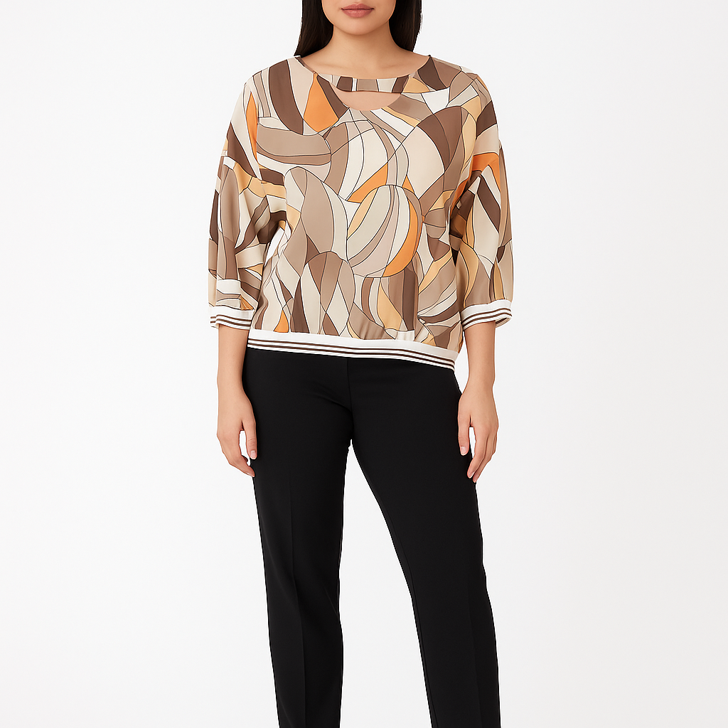 Woman wearing a patterned top and black pants on a white background