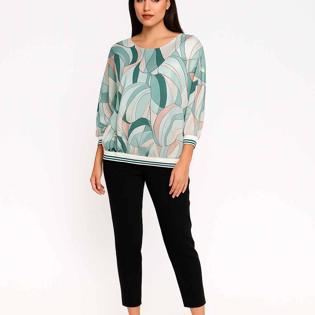 Woman wearing a patterned top and black pants on a white background