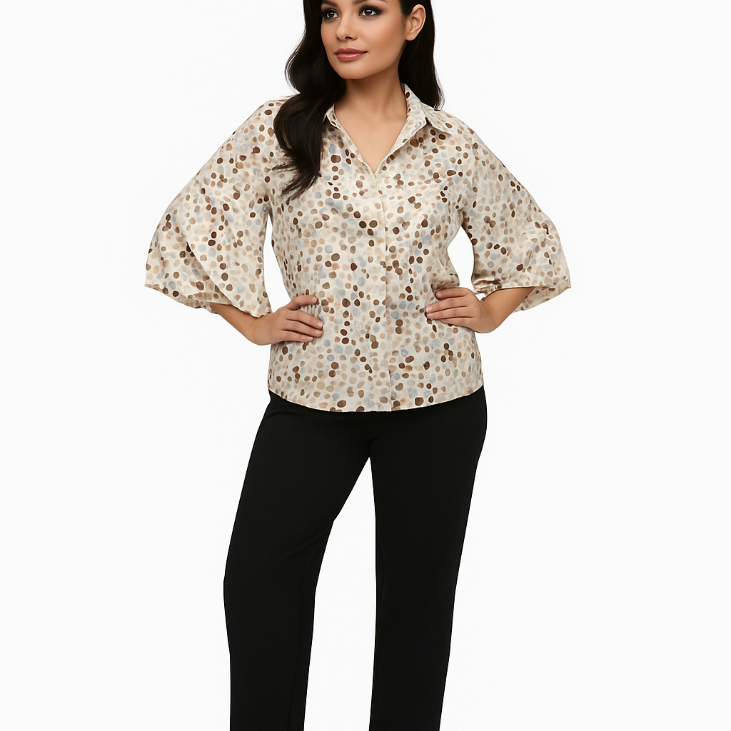 Woman wearing a patterned blouse and black pants on a white background