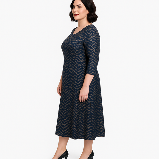 Woman wearing a dark blue patterned dress on a white background