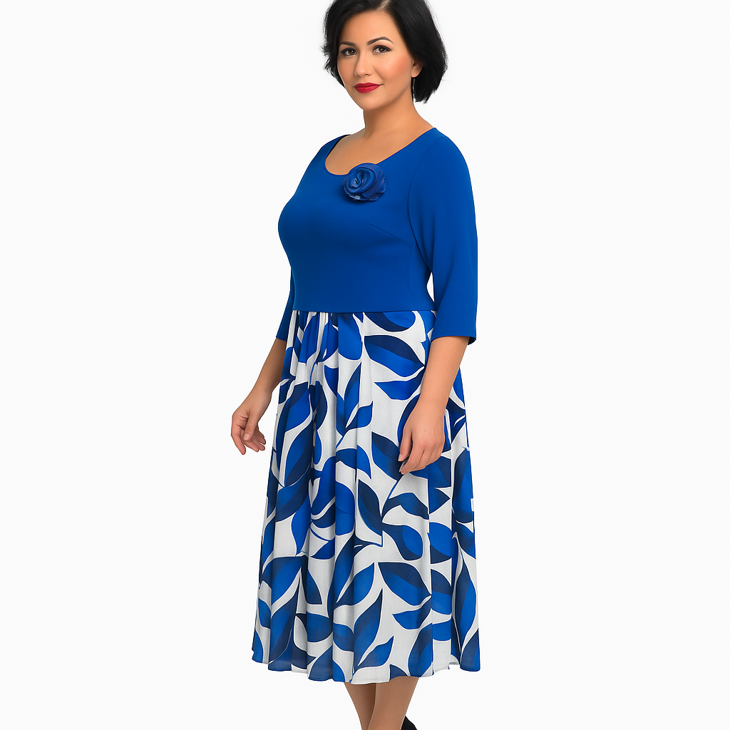 Woman wearing a blue top and white dress with blue leaf pattern on a white background