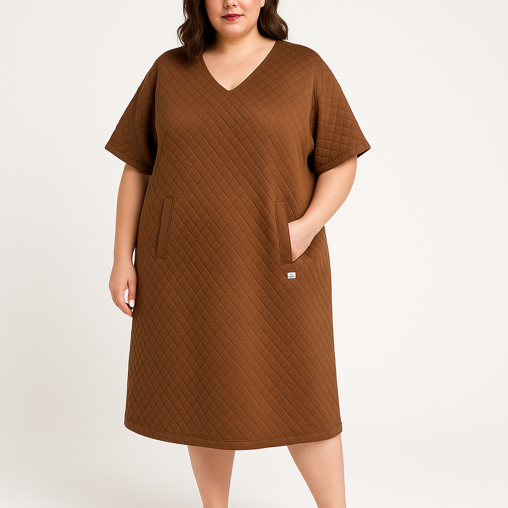Brown quilted dress worn by a model on a white background
