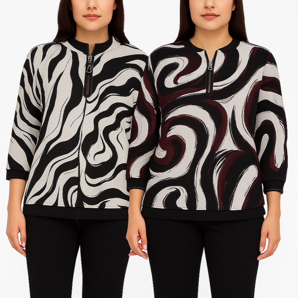 Two women wearing black and white patterned jackets on a plain background