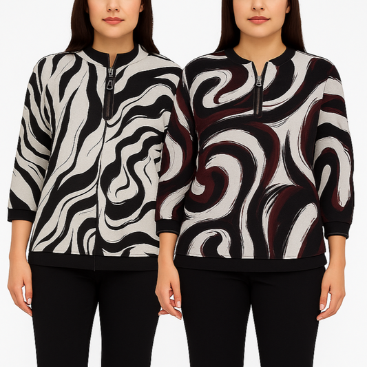 Two women wearing black and white patterned jackets on a plain background