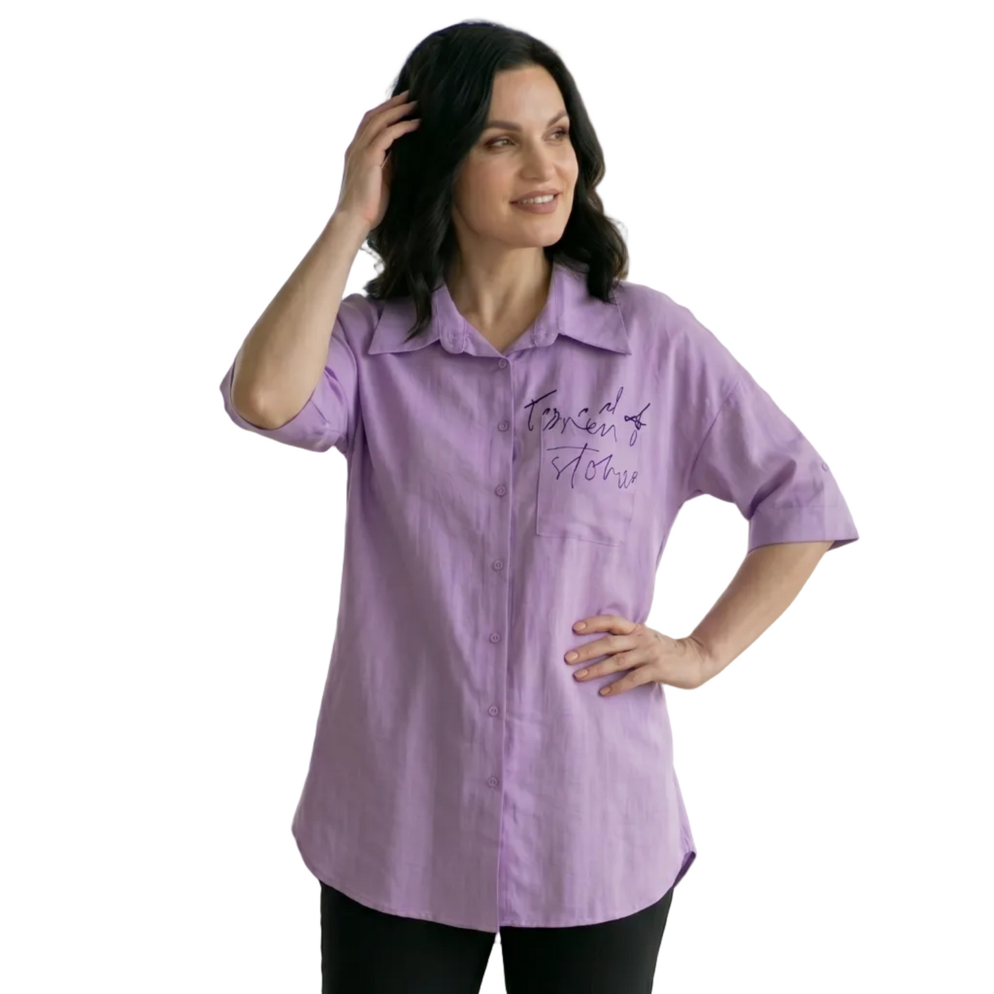 Woman wearing a purple shirt with text in an indoor setting