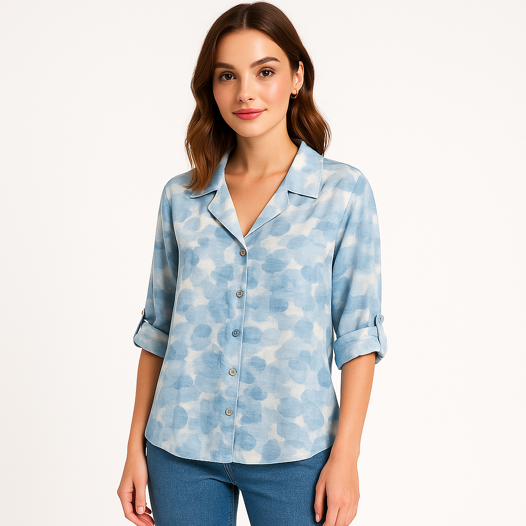 Moteris dėvi šviesiai mėlyną gėlėtą palaidinę, susiūtą su maikute – puikus pasirinkimas kasdieniam stiliui.