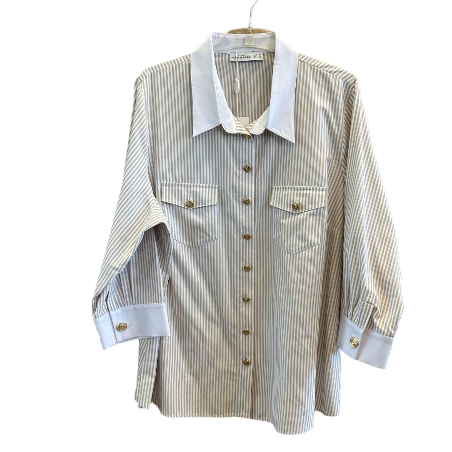 Smėlio spalvos dryžuoti marškiniai su balta apykakle ir auksinėmis sagomis, kabantys ant pakabos.