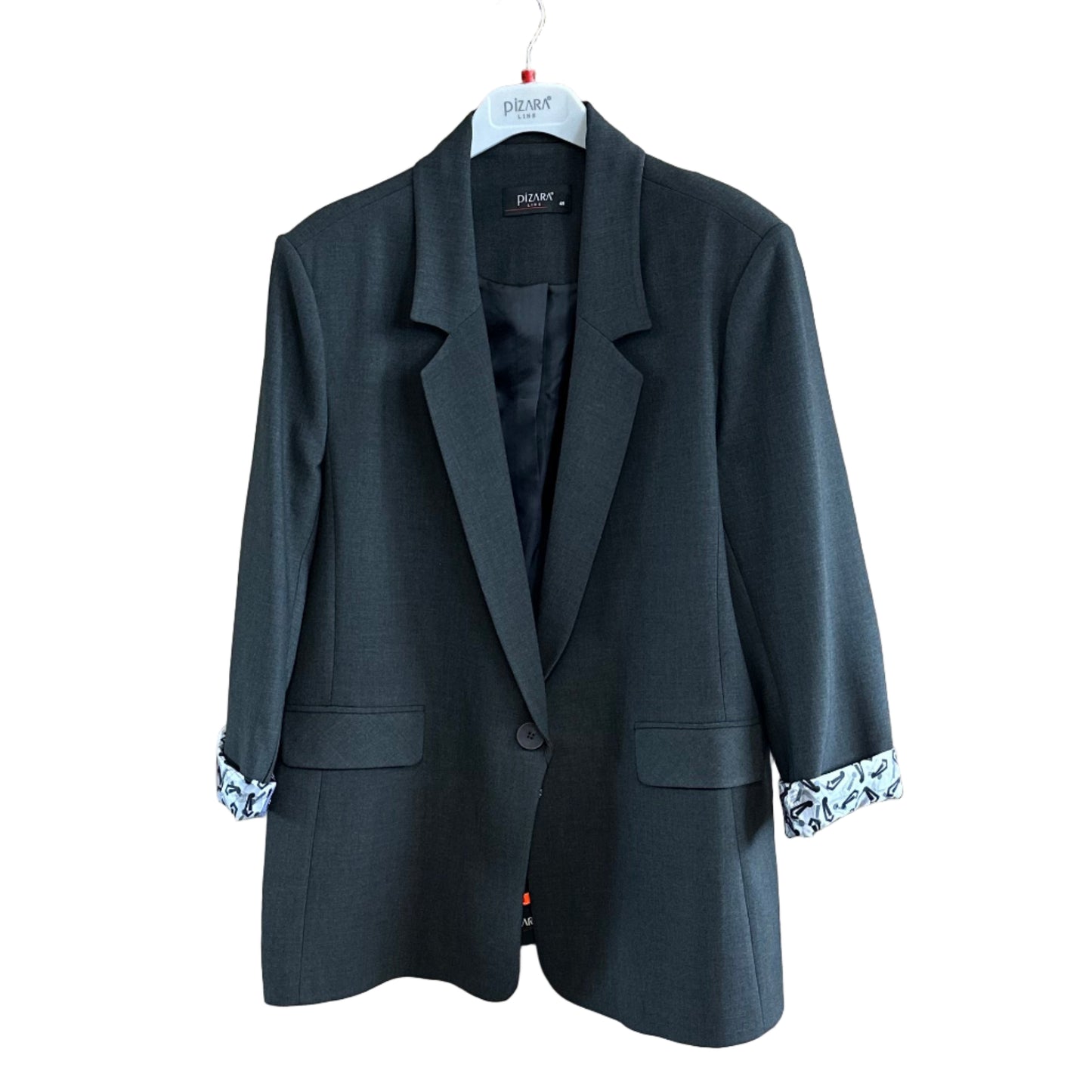 Black suit jacket on a wooden board with a mirror reflection in a clothing store.