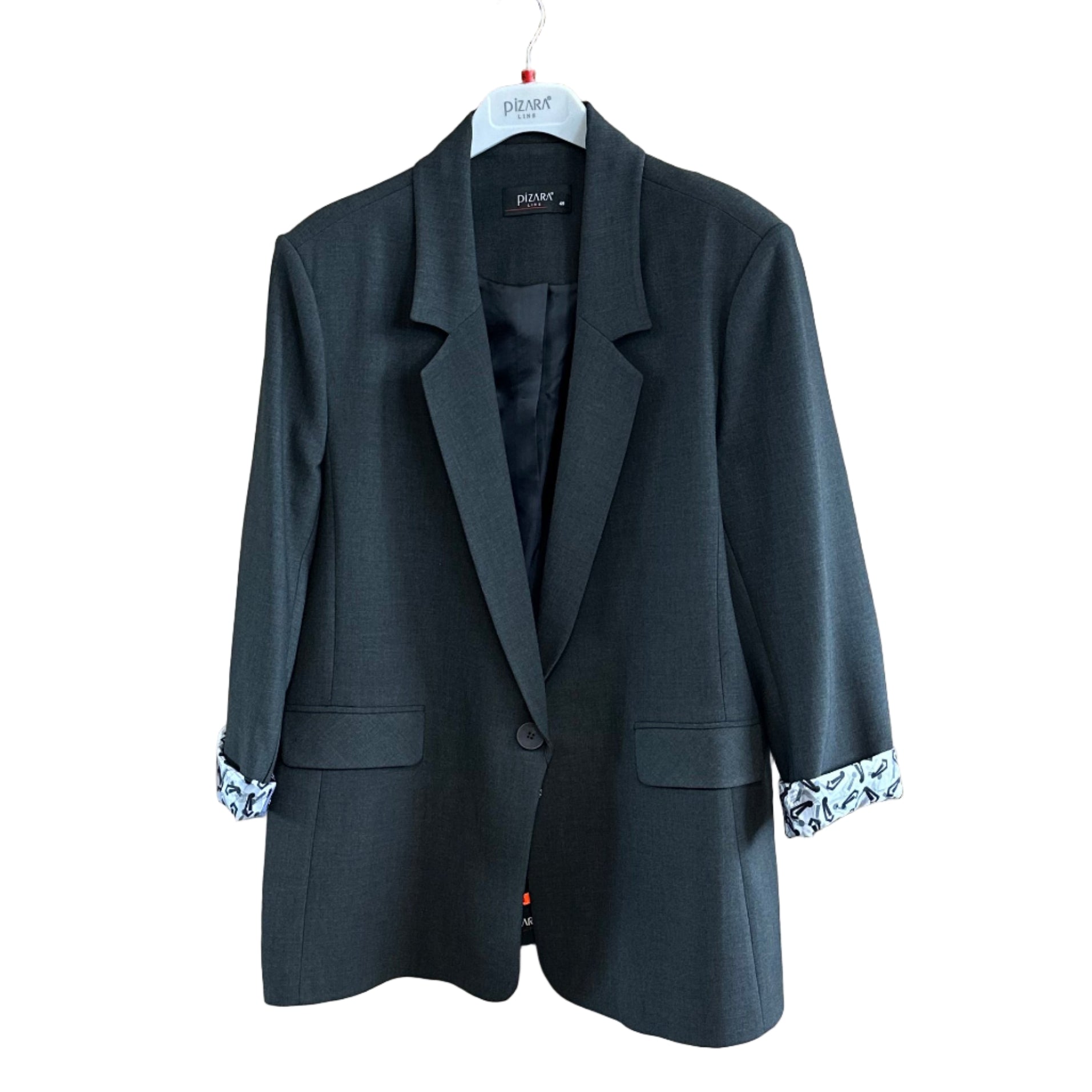 Black suit jacket on a wooden board with a mirror reflection in a clothing store.