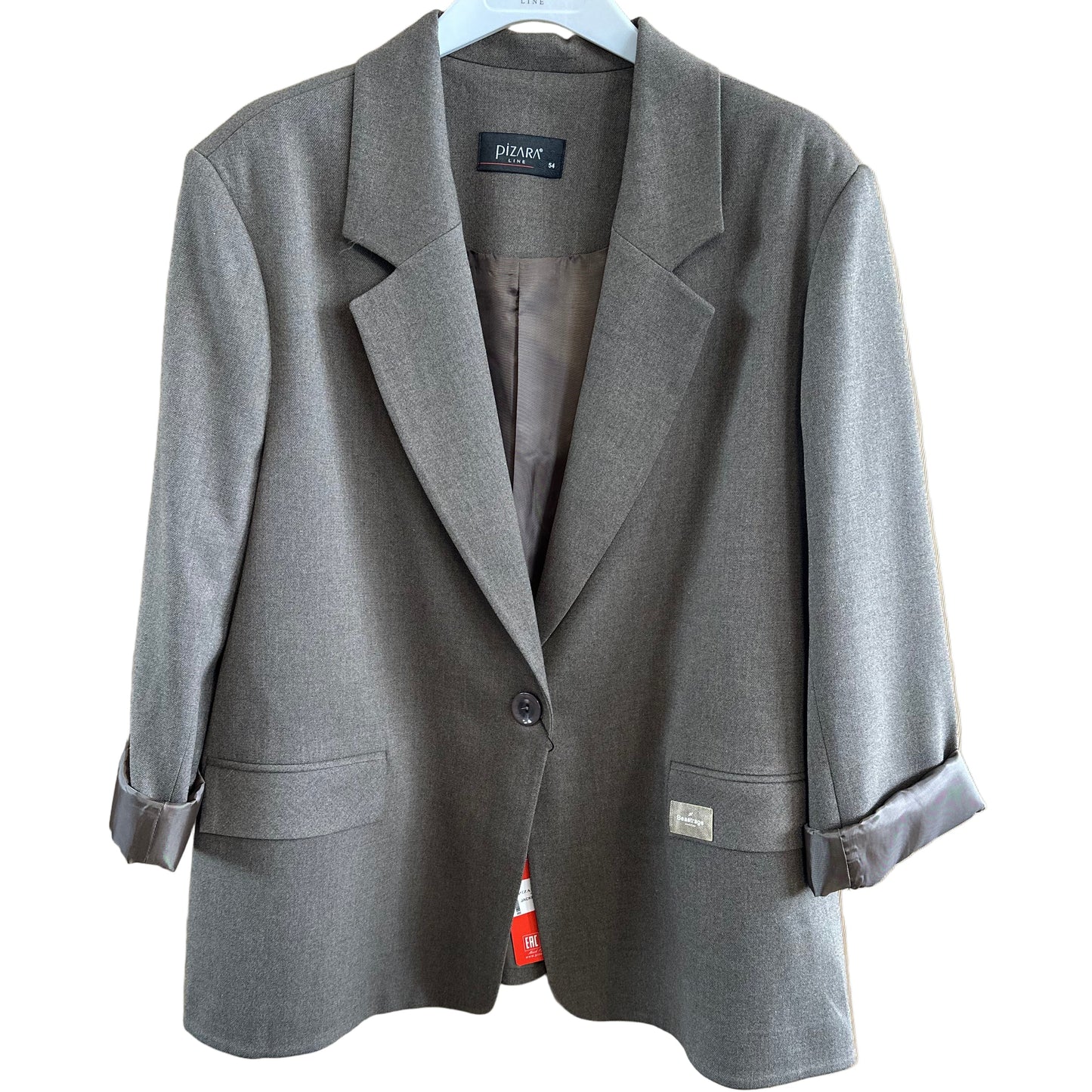 Folded gray jacket on a wooden surface