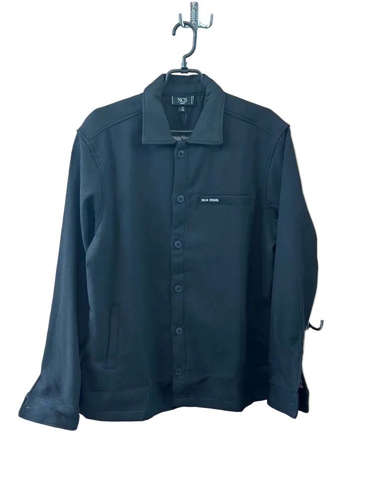 Dark black jacket on a hanger against a beige wall