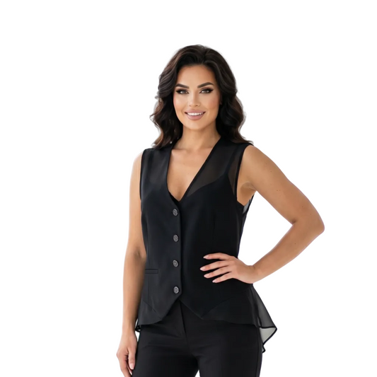 Woman wearing a black suit standing in a bright room with large windows.