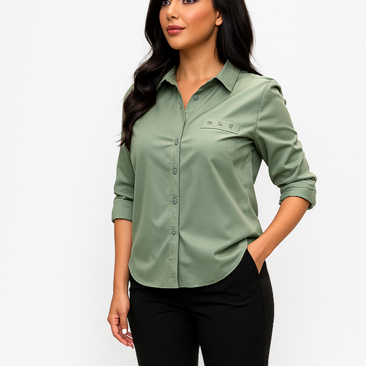 Woman wearing a green shirt and black pants on a white background