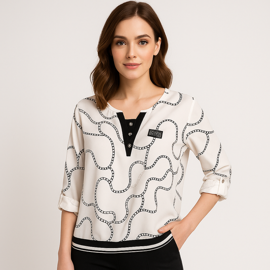 Moteriška lengva palaidinė su sagutėmis ir elastingu apačios kraštu, vilkima modelio.

