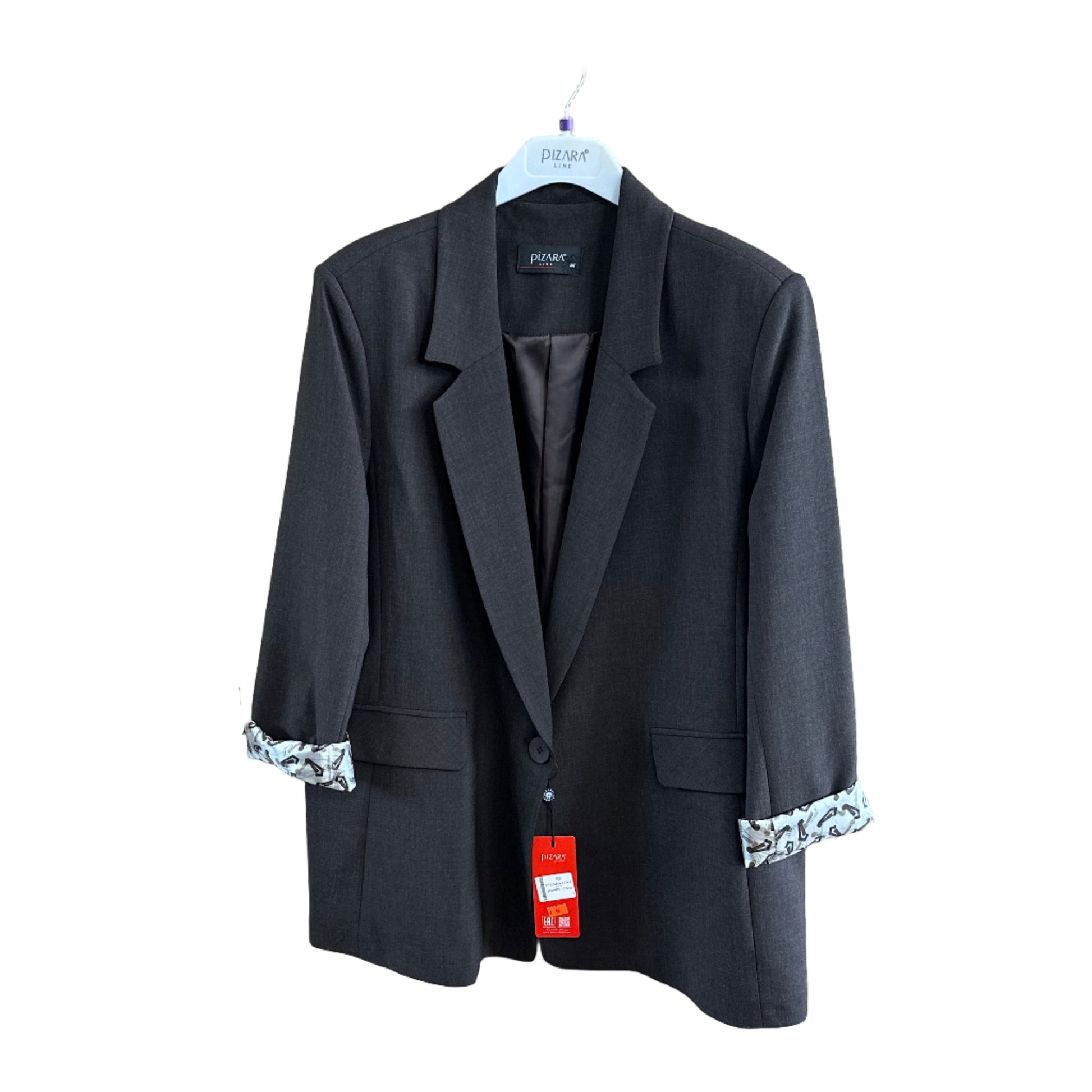 Black jacket on a wooden surface with tags attached