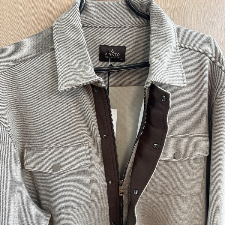 Gray jacket with a brand label on a hanger against a neutral background