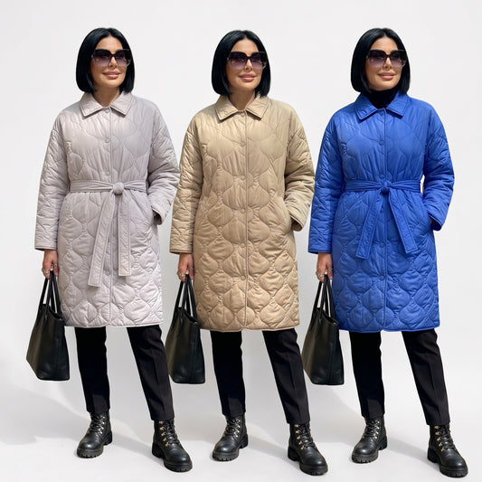 Three women modeling long quilted belted puffer coats in light gray, beige, and royal blue, standing against a plain white studio background.